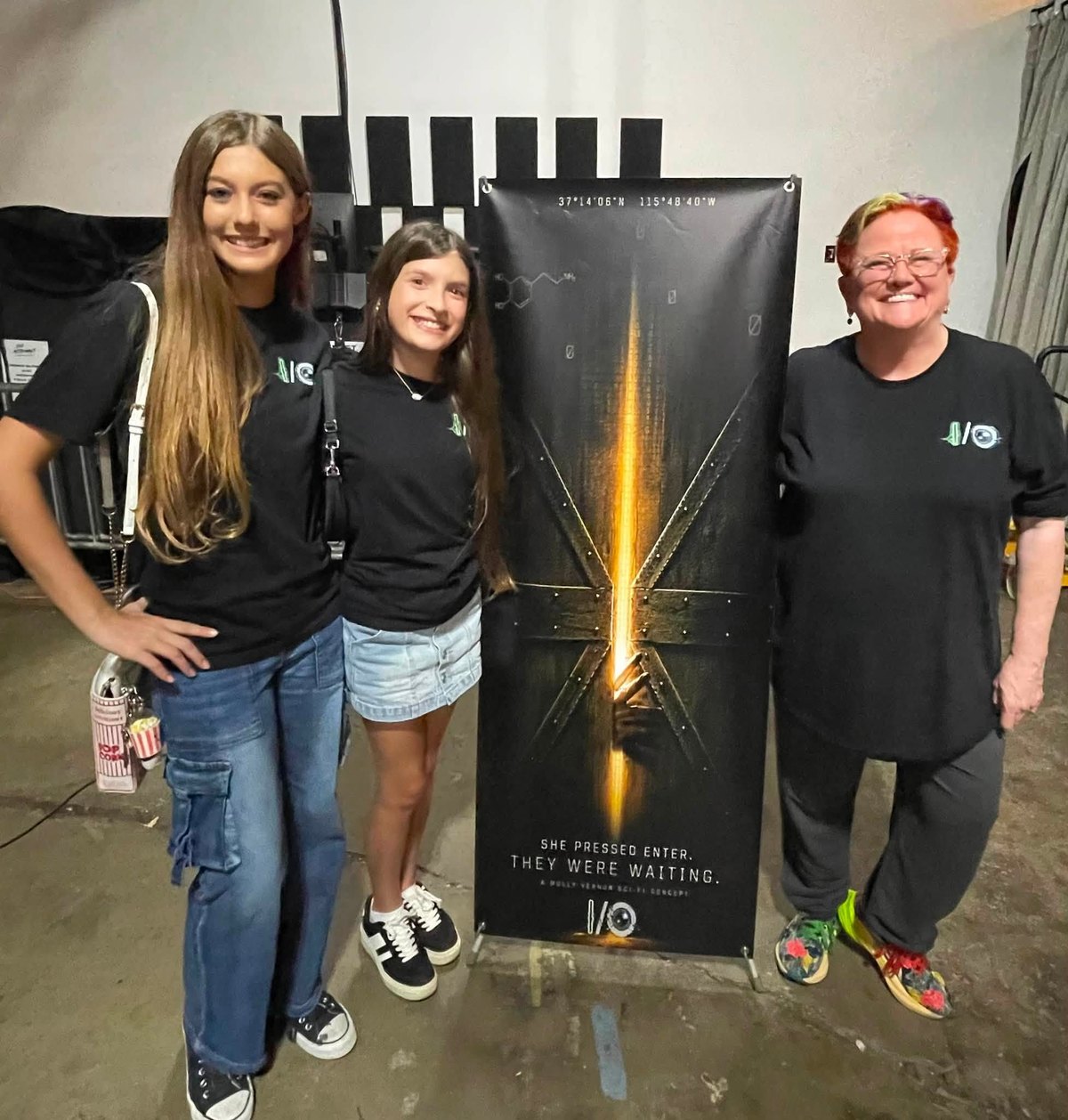 People in I/O shirts with the physical threshold banner.